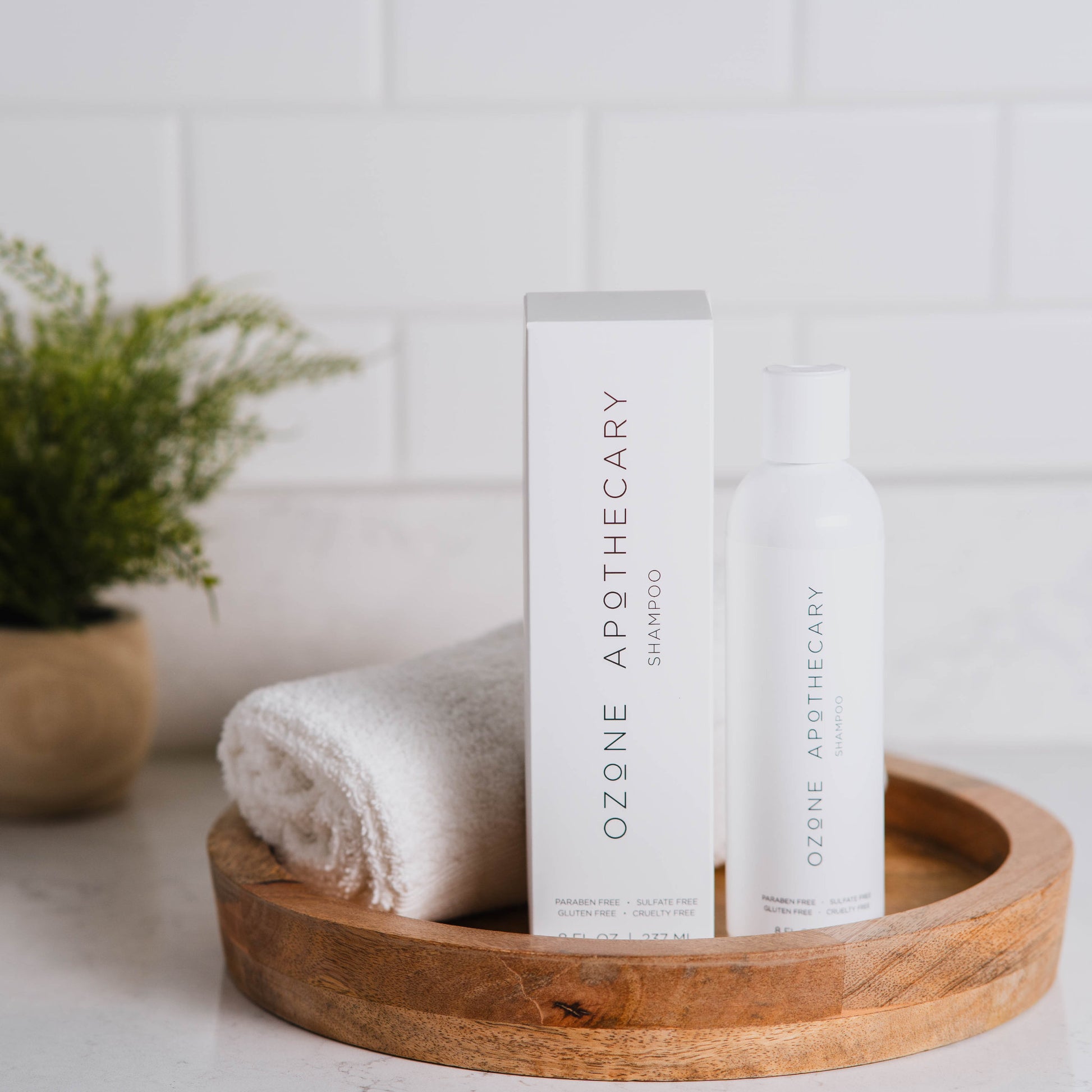 Ozone shampoo bottle and box on countertop with towel