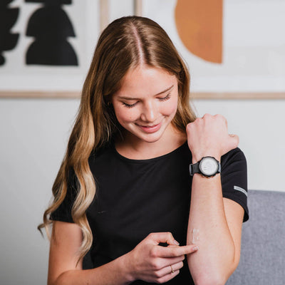 woman applying skincare product on the forearm