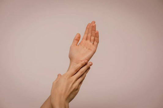 person resting one hand near the other hand