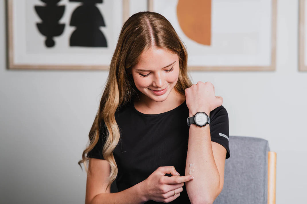 woman applying skincare product on the forearm
